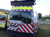 two ambulances parked next to each other on the grass