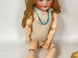 a doll that is sitting next to a box