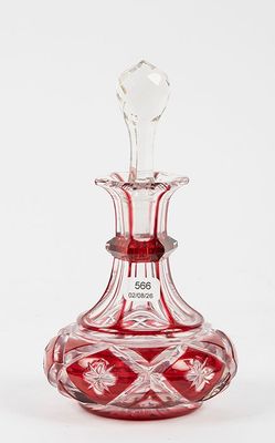 an image of a red glass decanter sitting on top of a white surface