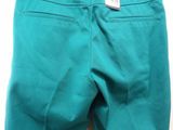 a pair of teal colored shorts hanging on a hanger
