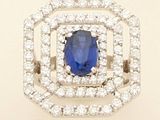 a close up of a blue sapphire and diamond ring on a white background