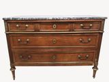 a marble top chest of drawers with brass handles