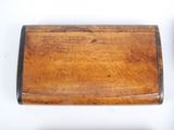 a small wooden box with a handle on a white surface