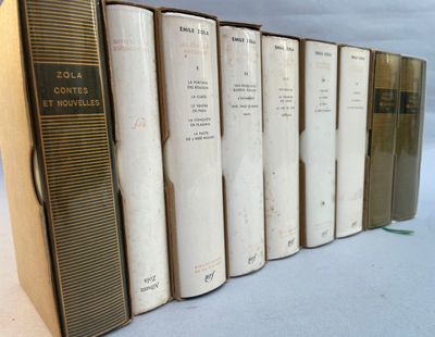 several books are lined up in a row on a white surface