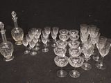 a lot of wine glasses and a decanter on a table
