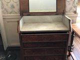 a dresser with a mirror on top of it in a room