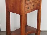 an image of a small wooden table with drawers on it