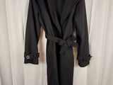 the coat is black and has a belt on the waist