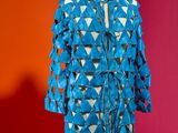 a mannequin on a stand with a blue jacket on it