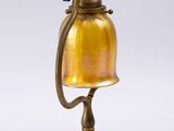 an antique brass lamp with a glass shade on a white background