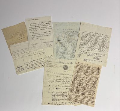 several old papers are stacked on top of each other on a table