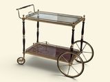 un chariot de bar en verre et en laiton, monté sur roulettes