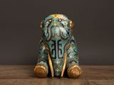 an elephant figurine sitting on top of a wooden table