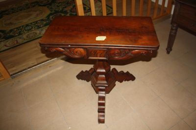 a small table with a wooden top on a tile floor
