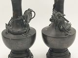 two vases that are sitting next to each other on a table
