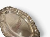 a silver tray that is shaped like a shell