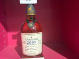 Des bouteilles d'alcool sont exposées dans une vitrine rose