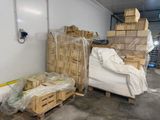 a pile of boxes and pallets in a warehouse
