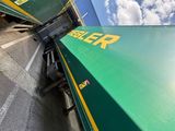 a green and yellow train traveling down the tracks