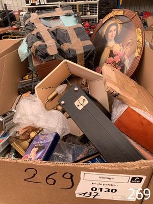 a cardboard box filled with luggage and other items