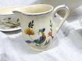 a pitcher and a cup sitting on a table