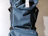 a blue bag with a tag on it sitting on a table
