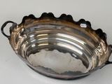 a silver bowl with handles on a white table