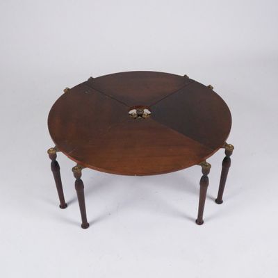 une image représentant une table ronde avec quatre pieds et un plateau en bois
