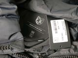 a close up of a zippered jacket with a name tag on it