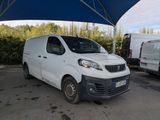 a white van that is parked under a blue umbrella