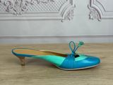 blue and green shoes on a wooden table with a wall in the background
