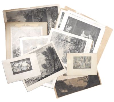 a lot of old black and white photographs on a table