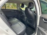 the back seats of a silver car with the door open