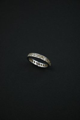 a close up of a silver ring on a black surface