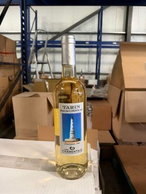 a bottle of wine sitting on a table in a warehouse