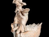 a figurine of a man riding on a boat