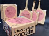 three boxes of chocolate are sitting on a table with a black background