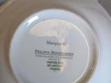 a white plate with a picture on it sitting on a table