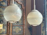 two lamps that are hanging from the ceiling in the room