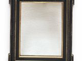 a close up of a mirror on a wall with a white background