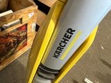 a yellow and black vacuum that is sitting on the floor