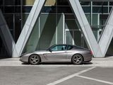 a silver sports car parked in front of a building