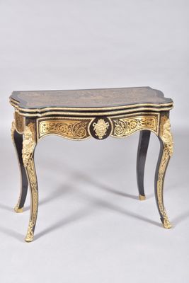 a pair of small tables with gold and black decoration