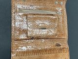 a close up of a wallet on a table with a black background