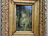 a painting of a man walking through a forest in a golden frame