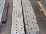 several pieces of metal are stacked on top of each other in a warehouse