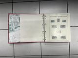 an open book with stamps on it sitting on a tiled floor