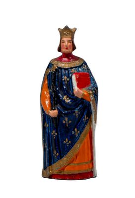 a figurine of a man wearing a crown and holding a book