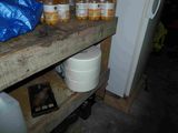a wooden shelf with bottles of liquid on it