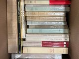 a box full of books that are stacked on top of each other